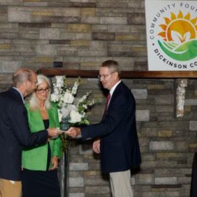 Brenda Holm and Tim Johnson recieve board retirement recognition from President Ray Wyatt